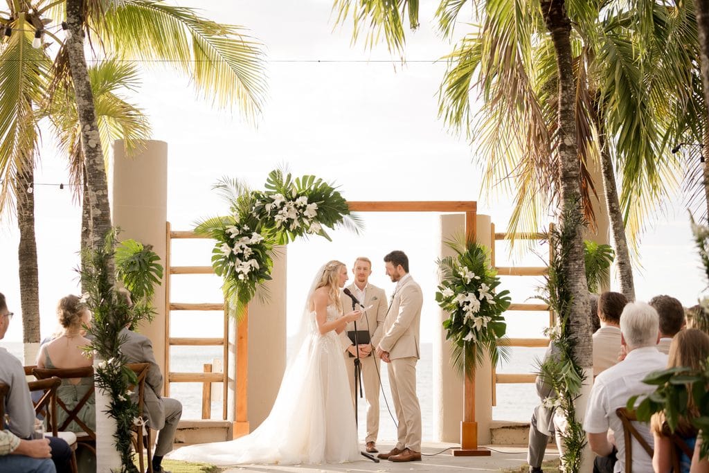 husband and wife at the altar during their wedding in costa rica