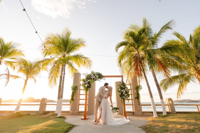 husband and wife kissing at the altar after the wedding