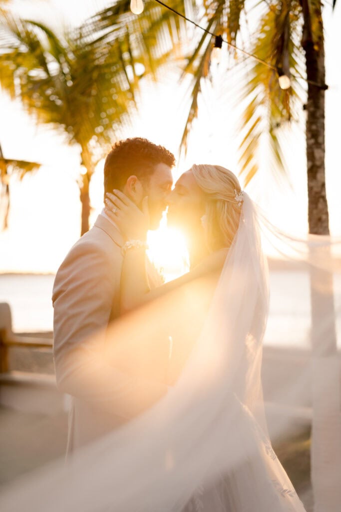 man and woman touching forehead in wedding attire in costa rica